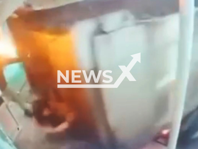 This image is a screen grab of the video supplied titled NewsX-ReverseCrowd-01.mp4: Video shows dump truck crashing twice intentionally reversed into a crowd of people standing on the porch of a cafe-bar in Novosibirsk, Russia on Sunday, Aug 10, 2025.(Clipzilla/NX)