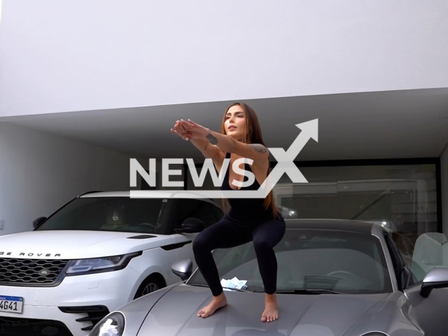 Fernanda Campos exercises on a Porsche, undated. The act was escribed as being dangerous. Note: Photo is a screenshot from a video. (Newsflash/NX)