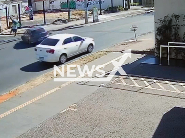 This image is a screen grab of the video supplied titled NewsX-FlyBik-01.mp4: Footage shows biker flying in the air after collision with car at intersection in Setor Sul, Goiania, Brazil on Wednesday, Aug 13, 2025.(Clipzilla/NX)