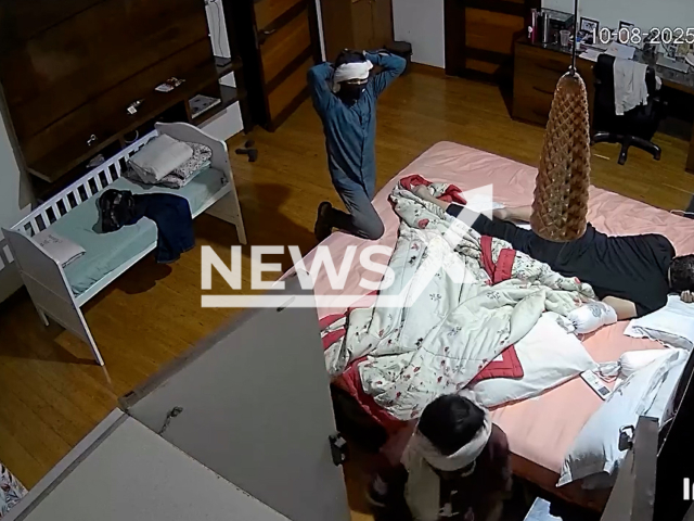 This image is a screen grab of the video supplied titled NewsX-RobHome-01.mp4: Security camera footage shows masked burglars armed with an iron rod calmly looting retired judge Justice Ramesh Garg’s Indore home in Indore, Madhya Pradesh, India on Sunday, Aug 10, 2025.(Clipzilla/NX)