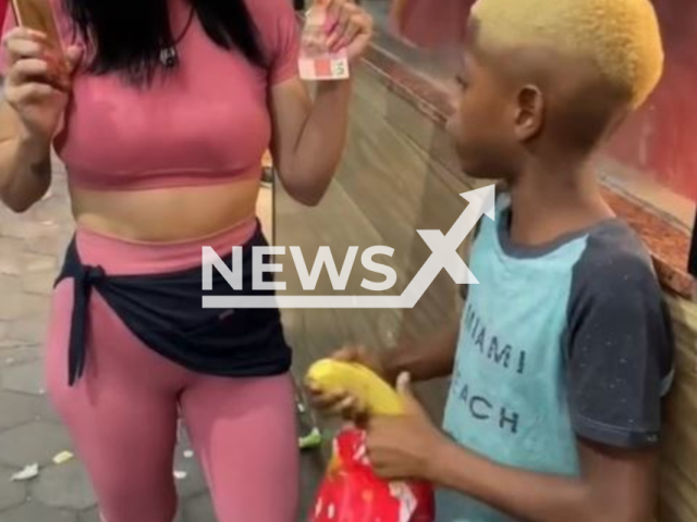 Influencer Nancy Goncalves gives banana  to black child, in Brazil, undated. She and Kerollen Cunha  gave bananas and monkey toy   to black children and are being  investigated for racism, in Brazil. Note: Picture is a screenshot from a video (@kerollenenancy_/CEN)