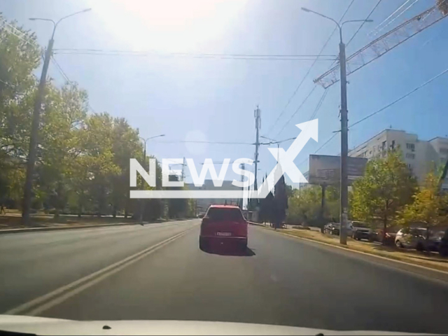 This image is a screen grab of the video supplied titled NewsX-CraneRoadColl-01.mp4: A crane collapses in Sevastopol, Russia, on Aug.15, 2025. At least one person died and two were injured.(Clipzilla/NX)