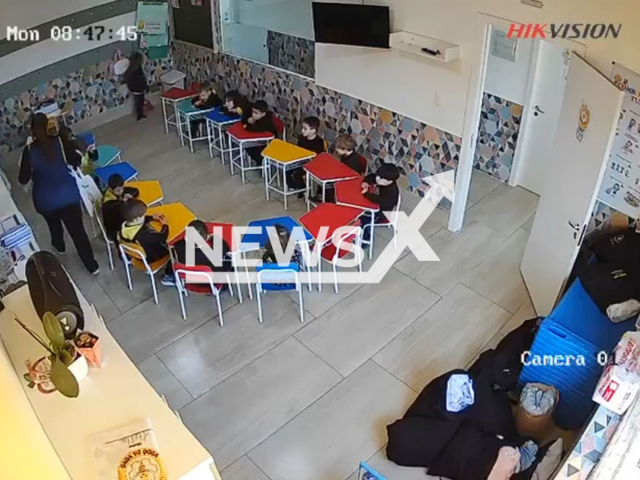 Teacher hits boy with a stack of books in Caxias do Sul, Brazil, Aug. 18, 2025. She claimed he fell in the bathroom. Note: Photo is a screenshot from a video(Newsflash/NX)