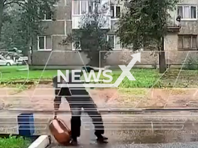 This image is a screen grab of the video supplied titled NewsX-ManTripExp-01.mp4: A large canister explodes as a man slips in Ufa, Russia, on Aug.20,2025.