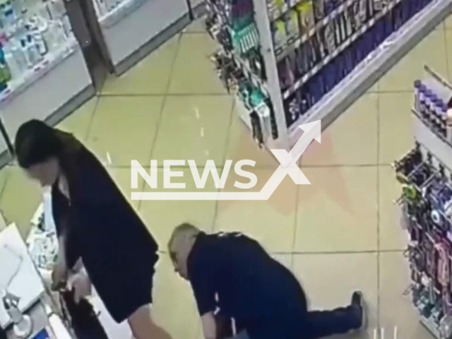 This image is a screen grab of the video supplied titled NewsX-PeekSkirt-01.mp4: CCTV footage shows man peeking under woman’s skirt in pharmacy in Moscow, Russia, undated. Footage shared on Vkontakte on Friday, Aug 22, 2025.(Clipzilla/NX)