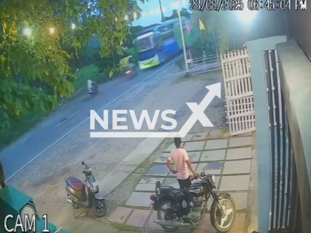 This image is a screen grab of the video supplied titled NewsX-OnCrash-01.mp4: CCTV shows speeding biker crashing into a bus, leaving the biker dead on the spot in Haldwani, Uttarakhand, India on Saturday, Aug 23, 2025.(Clipzilla/NX)
