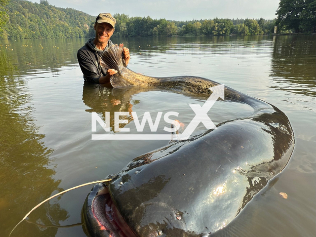 Jakub Vagner, 43, shows the 2.72-meter-long fish he caught in Czech Republic, undated. He improved his previous record of 2.68 meters from this summer. Note: Private photo taken from social media. (Jakub Vagner/Newsflash/NX)