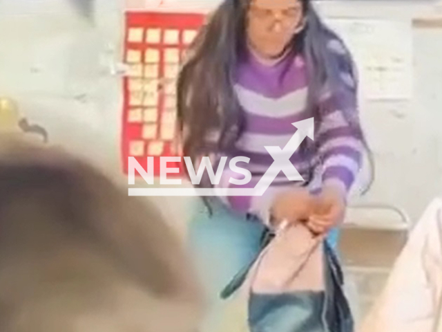 Teacher apparently steals from student's bag in Victoria, Entre Rios in Argentina, undated. The students decided to place a camera in the classroom to discover who was stealing money from their purses. Note: Photo is a screenshot from a video(Newsflash/NX)