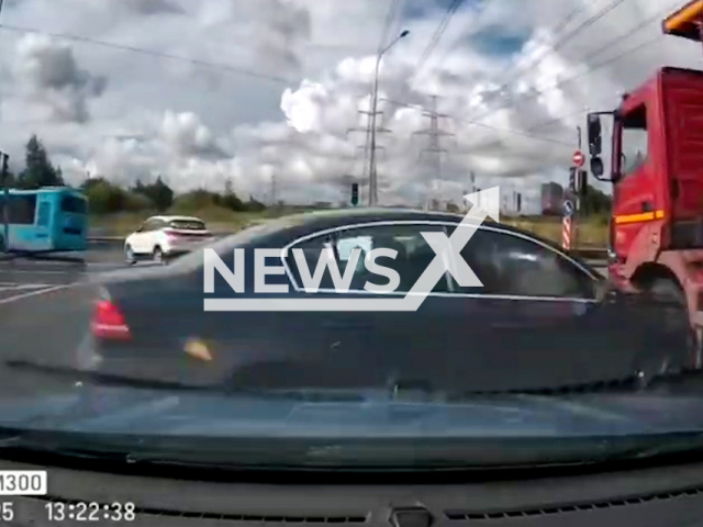 This image is a screen grab of the video supplied titled NewsX-RoadManeuver-01.mp4: Dashcam footage shows a car colliding with a truck after an improper manoeuvre at the intersection of Murinskaya Road and Piskarevsky Prospekt in Saint Petersburg, Russia on Tuesday, Aug 26, 2025.(Clipzilla/NX)