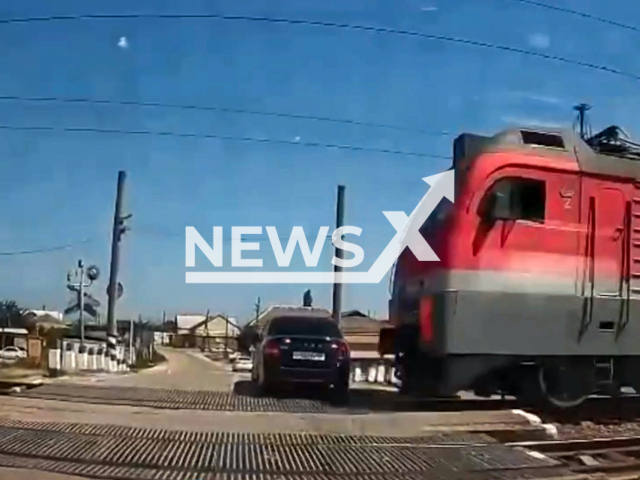 This image is a screen grab of the video supplied titled NewsX-TrainPass-01.mp4: Footage shows a train hitting a car at the Delichoban railway crossing in the Derbent region, Republic of Dagestan, Russia on Tuesday, Aug 19, 2025.(Clipzilla/NX)