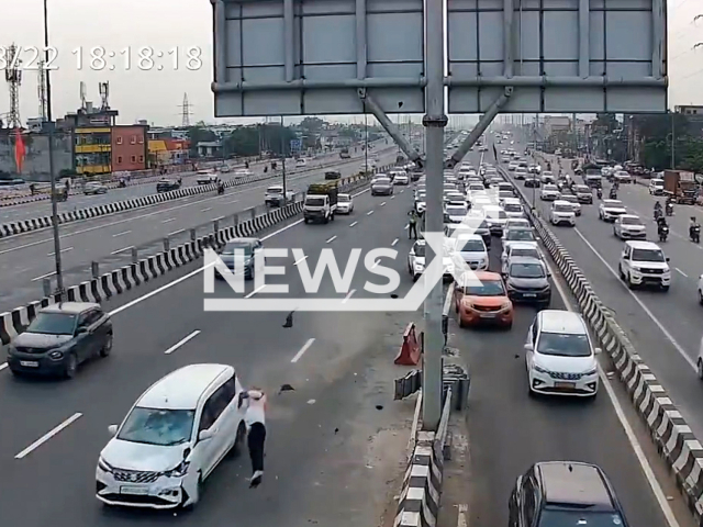 This image is a screen grab of the video supplied titled NewsX-WayConstable-01.mp4: Footage shows the speeding car hitting constable Vipin Kumar Singh near the exit point on Delhi–Meerut Expressway, India on Friday, Aug 22, 2025.(Clipzilla/NX)