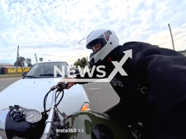 This image is a screen grab of the video supplied titled NewsX-IntersectionFlames-01.mp4: Footage shows motorcycle bursts into flames after crash at Oktyabrsky District, Perm Krai, Russia on Saturday, Aug. 23, 2025.( Clipzilla/NX)