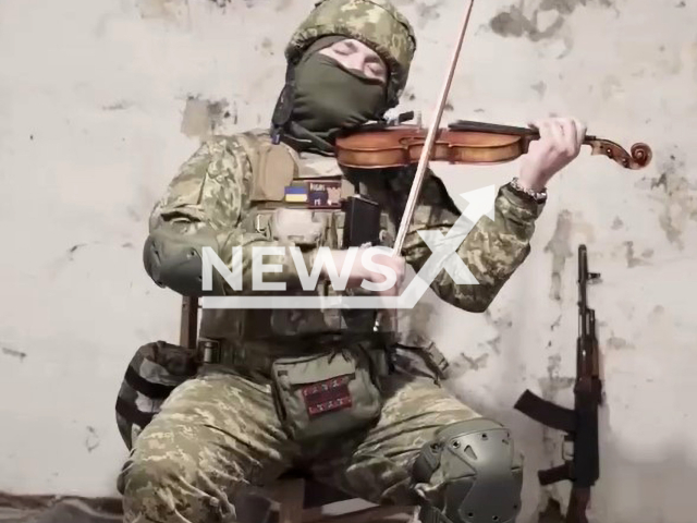 Ukrainian soldier Moysey plays violin in bomb shelter in Odessa in Ukraine.  Note: Image is screenshot from video. (@paranoizes/Newsflash)