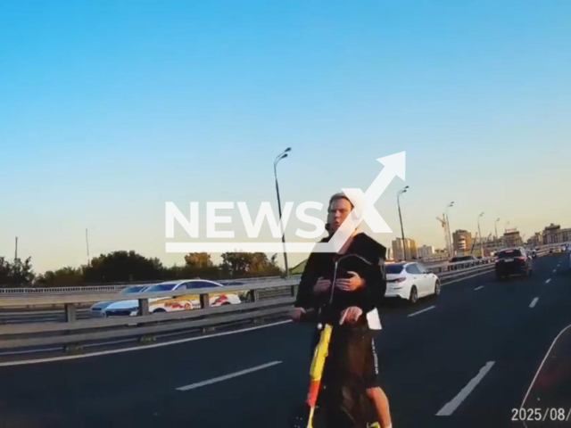 This image is a screen grab of the video supplied titled NewsX-AgainstTraffic-01.mp4: Footage shows two teenagers on a scooter ride against traffic on Mira Avenue, Moscow, Russia on Sunday, Aug 31, 2025.(Clipzilla/NX)
