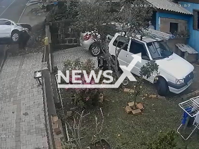 This image is a screen grab of the video supplied titled NewsX-SmeshCresh-01.mp4: CCTV shows driver being thrown and crushed by his own car in Sao Lourenço do Oeste, Brazil on Sunday, Aug 31, 2025.(Clipzilla/NX)