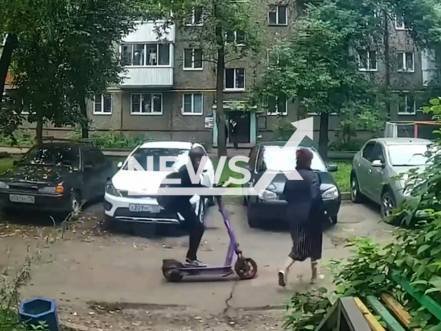 This image is a screen grab of the video supplied titled NewsX-ScooterTeen-01.mp4: Footage shows a teenager on an electric scooter hits a woman who was walking in the same direction and flees in Ufa, Russia on Monday, Sep. 1, 2025.(Clipzilla/NX)