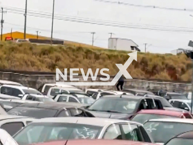 This image is a screen grab of the video supplied titled NewsX-PoliceSmugle-01.mp4: Footage shows man who runs over cars to escape the Federal Revenue in Parana, Brazil on Monday, Sep 1, 2025.(Clipzilla/NX)