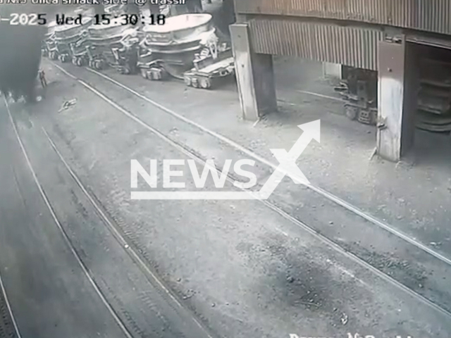 This image is a screen grab of the video supplied titled NewsX-FallDust-01.mp4: CCTV footage shows a locomotive assistant being buried under collapsing metal shavings near a blast furnace, leaving him with injuries that led to both legs being amputated in Novotroitsk, Orenburg region, Russia on Wednesday, Aug. 20, 2025.(Clipzilla/NX)