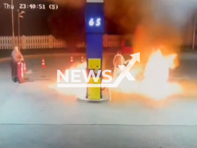 This image is a screen grab of the video supplied titled NewsX-GasFire-01.mp4: CCTV footage captures the moment a 34-year-old drunk man ignites a gas station pump, engulfing an employee in flames in Faget, Timis, Romania, on Thursday, Sep. 4, 2025.(Clipzilla/NX)