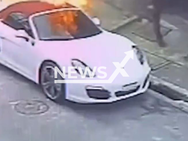 This image is a screen grab of the video supplied titled NewsX-LiteSpens-01.mp4: Footage shows two men on a motorcycle setting on fire Porsche on Ferdinando Paer Street, Jardim Celia, South Zone of Sao Paulo, Brazil on Sunday, Sep. 7, 2025.(Clipzilla/NX)