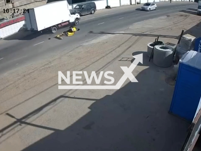 This image is a screen grab of the video supplied titled NewsX-CourierLanes-01.mp4: Footage shows a scooter rider making a dangerous maneuver and colliding with a Gazelle in Dzerzhinsky, Moscow Oblast, Russia on Friday, Sep. 5, 2025.(Clipzilla/NX)
