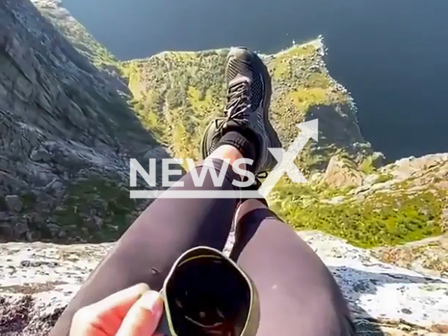 Hiker chilling on top of Kjerag, Norway. Note: This picture is a screenshot from the video. (@hikingexplores/Clipzilla)