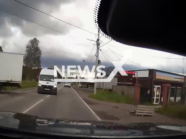 This image is a screen grab of the video supplied titled NewsX-AmbRoad-01.mp4: Dashcam footage shows a Gazelle truck reversing from a store and forcing an ambulance into the oncoming lane, as the filming driver swerves right to avoid a collision but crashes into a pole in Leningrad Oblast, Russia on Tuesday, Aug 19, 2025.(Clipzilla/NX)