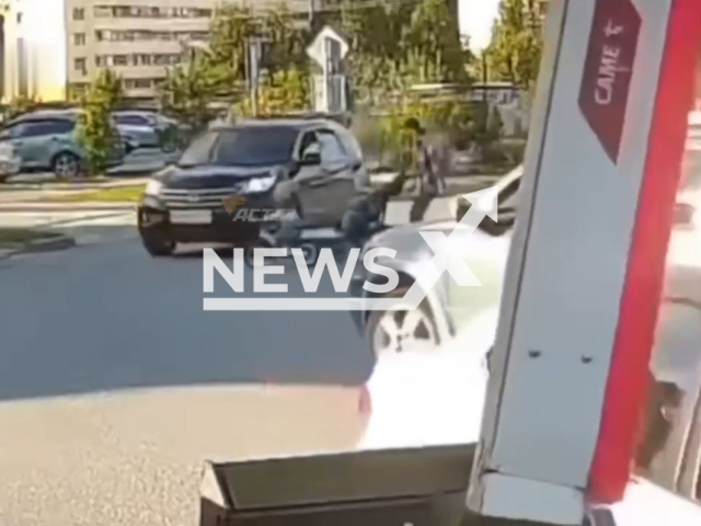 This image is a screen grab of the video supplied titled NewsX-FourHit-01.mp4: Footage shows Honda CR-V hitting a child at a pedestrian crossing in village Elite in the Novosibirsk District of the Novosibirsk Region of Russia on Friday, Sep. 5, 2025.