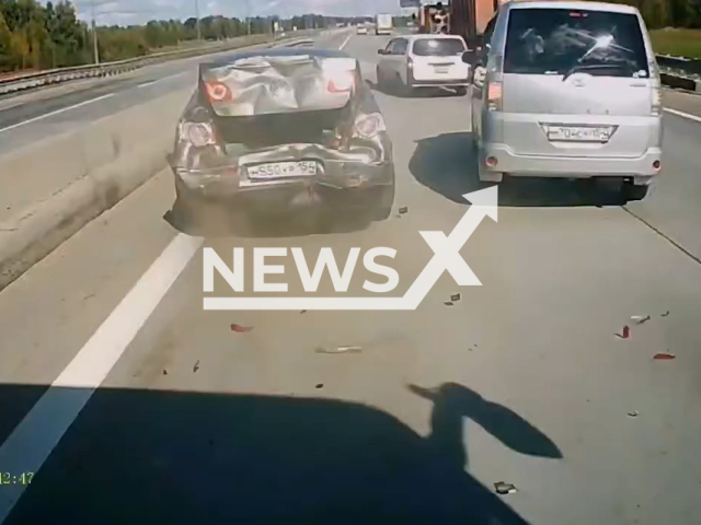 This image is a screen grab of the video supplied titled NewsX-LaneBlame-01.mp4: CCTV footage shows a Volkswagen changing lanes from left to right before being rear-ended by a bus that did not brake on a highway in Novosibirsk Oblast, Russia on 27th August, 2025.(Clipzilla/NX)