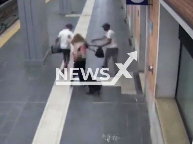 This image is a screen grab of the video supplied titled NewsX-RoberyTourists-01.mp4: Footage shows a woman being robbed by two men near the train station in Foggia, Italy, undated. Foggia Police released the CCTV video on Friday, Sep. 12, 2025.(Clipzilla/NX)