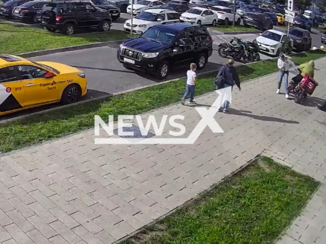 This image is a screen grab of the video supplied titled NewsX-ScootCourierStrong-01.mp4: Footage show a scooter courier hitting a girl and falling down in Balashikha, Moscow Oblast, Russia on Saturday, Sep. 13, 2025.(Clipzilla/NX)