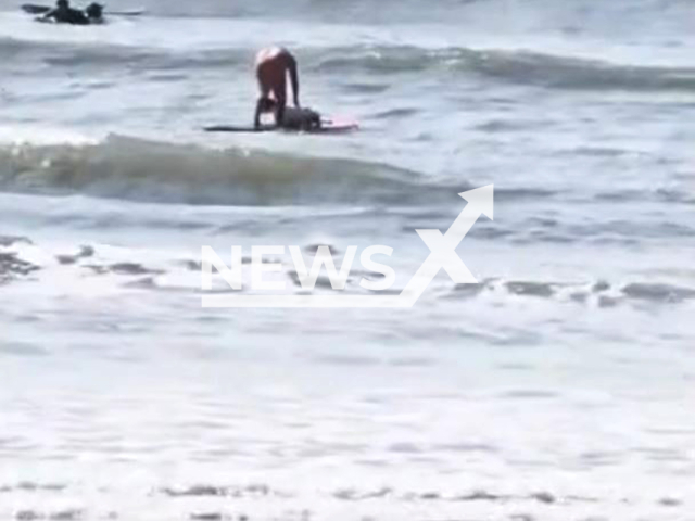 Man attacks dog on a paddleboard in the ocean in Sao Vicente, Brazil, Sep. 11, 2025. The animal fell in the water several times. Note: Photo is a screenshot from a video(Newsflash/NX)