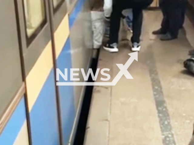 People rescue a man who fell on the track at the Moscow Metro, Russia, on Sept.17, 2025. He survived. Note: Photo is a screenshot from a video(Newsflash/NX)