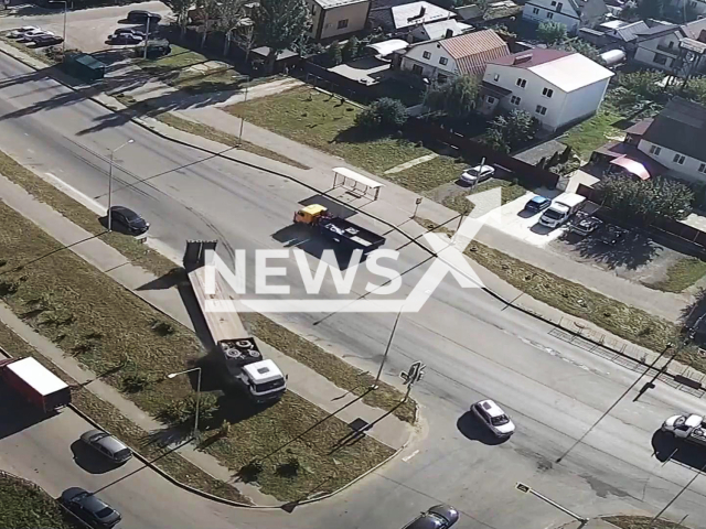 This image is a screen grab of the video supplied titled NewsX-TruckSwerve-01.mp4: Footage shows a truck with a trailer veering off the road and onto a lawn in Tambov, Russia on Thursday, Sep. 11, 2025.(Clipzilla/NX)
