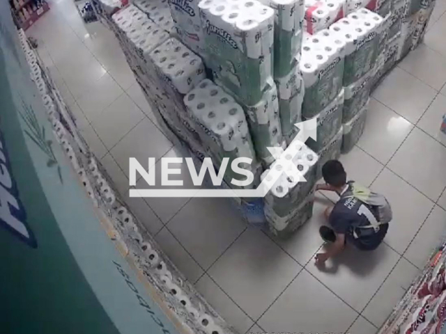 This image is a screen grab of the video supplied titled NewsX-PaperFire-01.mp4: Footage shows a 10-year-old boy setting paper towels on fire at a supermarket in Bursa, Turkey on Friday, Sep. 12, 2025.(Clipzilla/NX)