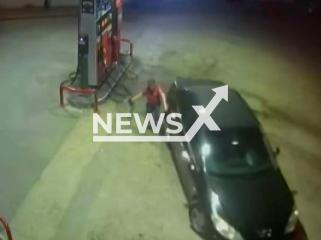 This image is a screen grab of the video supplied titled NewsX-CarPump-01.mp4: Footage shows  a driver at a gas station forgetting to pull the handbrake, causing his car to roll forward until station attendant quickly removed the fuel pump, held the tank to stop it, and the driver ran back to secure the vehicle in Bursa, Turkey on Monday, 15, 2025.(Clipzilla/NX)