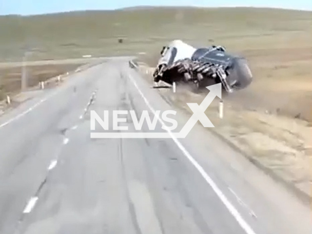 This image is a screen grab of the video supplied titled NewsX-ProfControl-01.mp4: Footage shows a truck speeding and swerving dangerously before veering off the road into a ditch and overturning on its roof on the Chita–Zabaikalsk highway in Transbaikal, Far Eastern Russia on Wednesday, Sep. 17, 2025.(Clipzilla/NX)