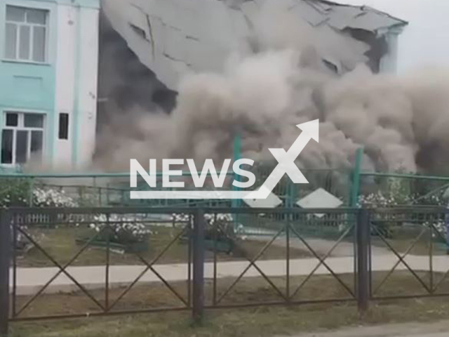 This image is a screen grab of the video supplied titled NewsX-SchoolCollapse-01.mp4: Footage shows a two-story school building collapsing in Tatarsk, Novosibirsk Oblast, Russia on Sunday, Sep. 21, 2025.(Clipzilla/NX)