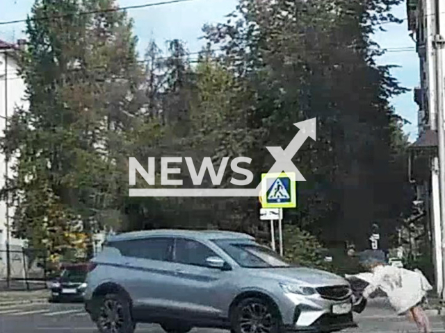 This image is a screen grab of the video supplied titled NewsX-HeelsRoad-01.mp4: Footage shows a woman in high heels struck by a car on a zebra crossing, but she lands on her feet and keeps walking in Vladimir, Russia on Thursday, Sep. 18, 2025.(Clipzilla/NX)
