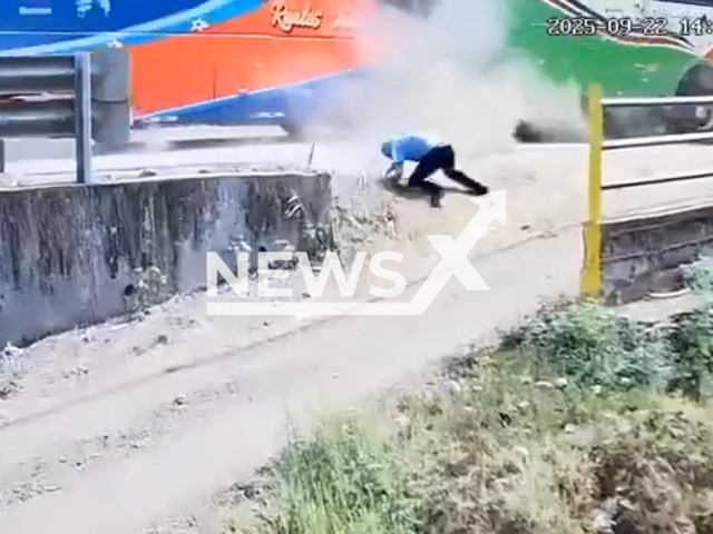 This image is a screen grab of the video supplied titled NewsX-DriverBused-01.mp4: Two buses crash sending one of them onto the edge of an abyss in Portoviejo, Ecuador, on Monday, 22 September 2025. Several people were injured.(Clipzilla/NX)