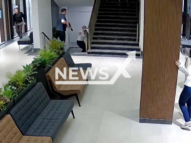 This image is a screen grab of the video supplied titled NewsX-KillerRestraining-01.mp4: CCTV footage shows Atilla Ayintapli, 44 killing Eser Karaca, 42 with a shotgun at the private hospital where his ex-wife worked Kahramanmaras, Turkey on the 21st of May, 2025.(Clipzilla/NX)