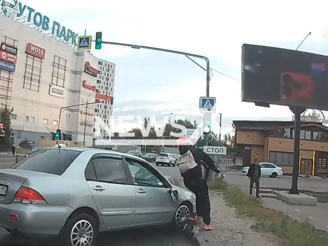 This image is a screen grab of the video supplied titled NewsX-MirrorFight-01.mp4: Dashcam shows the rider of an electric scooter kicking the mirror of a passing car, after which the car runs over the offender and knocks him off the vehicle in Reutov, Moscow Oblast, Russia on Thursday, Sep. 18, 2025.(Clipzilla/NX)