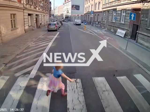 This image is a screen grab of the video supplied titled NewsX-BusPols-01.mp4: Footage shows a five-year-old girl running into a crosswalk on a red light, forcing the driver of the bus to brake immediately narrowly escaping hitting the child in Bytom, Poland on  Monday, Sep. 22, 2025.(Clipzilla/NX)