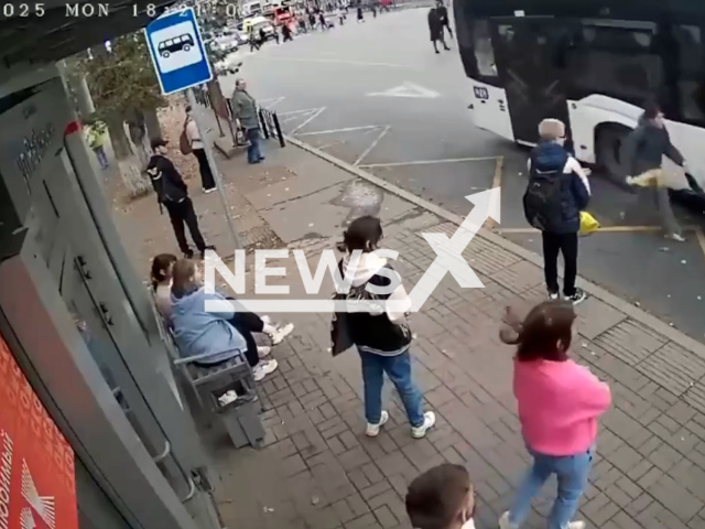 This image is a screen grab of the video supplied titled NewsX-ClosingDoor-01.mp4: CCTV footage from Omsk shows a bus driver closing the doors on a woman and her 5-year-old child; the boy, who had stepped onto the running board, was trapped and dragged several meters in Omsk, Russia on Monday, Sep. 22, 2025.(Clipzilla/NX)