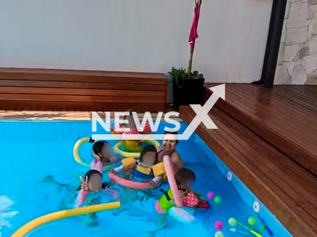 Picture shows grandmother with grandchildren inside swimming pool in Trindade, Brazil, undated. She saved them from drowning. Note: Private photo. (Newsflash/NX)