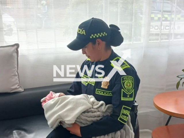 Picture shows the police officer with the baby she was breastfeeding, undated. The baby was showing signs of hunger in Bogota, Colombia. Note: Police photo. (Bogota Metropolitan Police/Newsflash/NX)