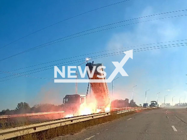 This image is a screen grab of the video supplied titled NewsX-TrayPower-01.mp4: Footage shows truck tray hitting power lines at Tula-Novomoskovsk highway, Tula Oblast, Russia on Tuesday, Sep. 30, 2025.(Clipzilla/NX)