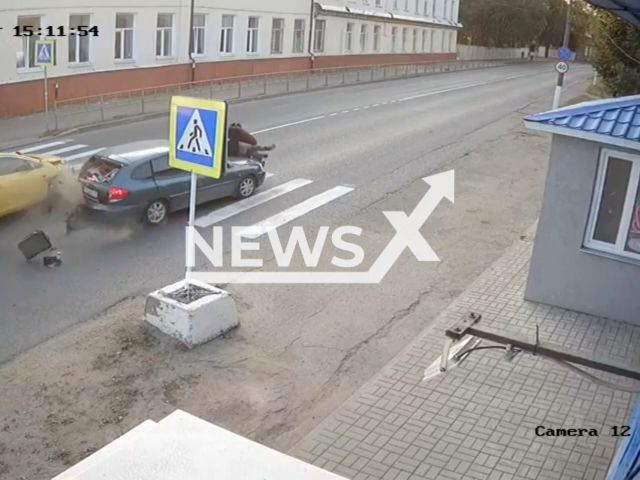 This image is a screen grab of the video supplied titled NewsX-PedRam-01.mp4: CCTV footage shows a stopped car being rammed from behind and hits two people as a result of a hit in Vyazma, Smolensk Oblast, Russia on Tuesday, Sep. 16, 2025.(Clipzilla/NX)