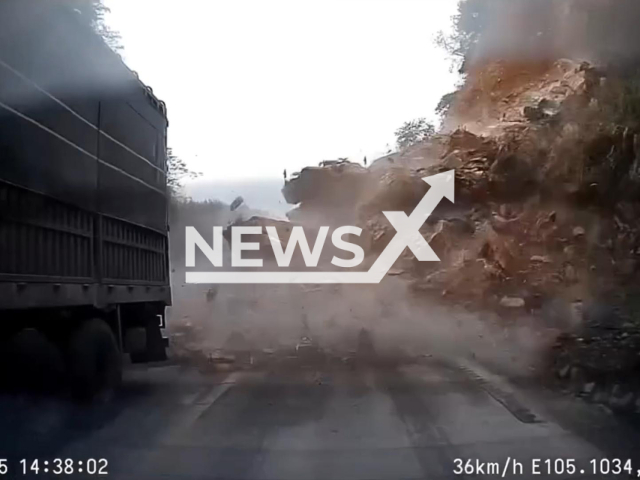 This image is a screen grab of the video supplied titled NewsX-LandSlideSite-01.mp4: Footage shows landslide burying people and vehicles at National Highway, Phu Thọ province, Vietnam on Sunday, Dec. 14, 2025.(Clipzilla)
