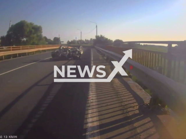 This image is a screen grab of the video supplied titled NewsX-CrashFatal-01.mp4: Footage shows a driver speeding, overtaking a BMW motorcycle, then losing control while changing lanes and crashing into a metal barrier in Suzdal, Vladimir Oblast, Russia on 11th of July, 2025.(Clipzilla)